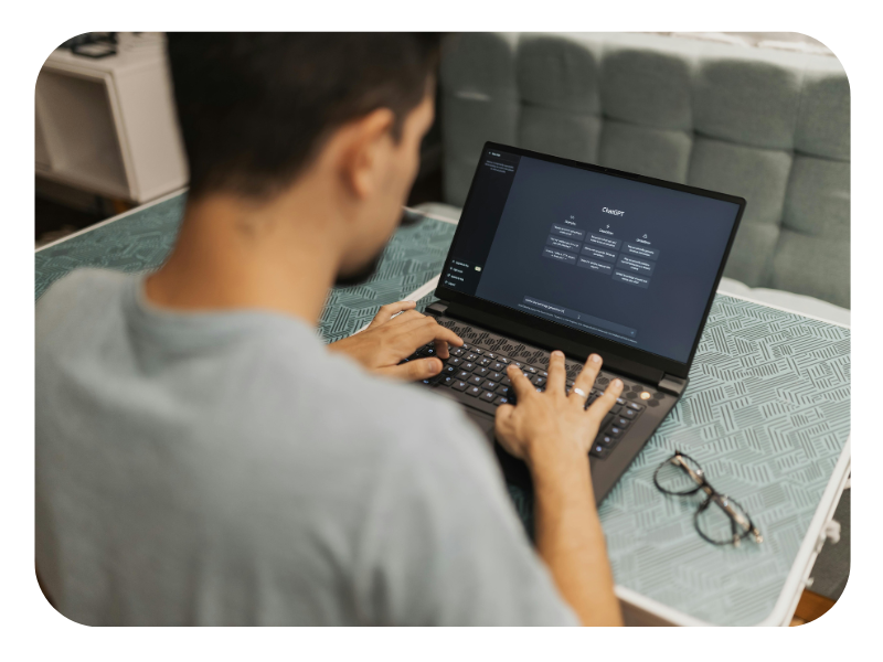 A man typing on a laptop showing the screen of chat gpt. This image is demonstrating the use of AI in digital marketing.