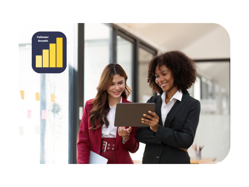 Two young professionals in business attire reviewing content on a digital tablet, with a "Follower Growth" chart nearby, capturing professional development and success in marketing apprenticeships.