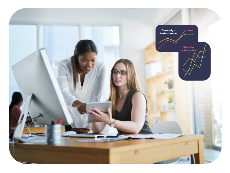 Two professionals collaborating on a digital campaign in an office, representing hands-on learning through Digital Marketing Apprenticeships Birmingham.