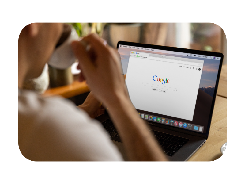 Person using a laptop with Google search engine open, representing the importance of local SEO for improving online visibility.